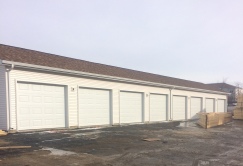 a bunch of plain white garage doors without windows