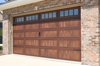 wooden garage door with hardware and windows with vertical slates
